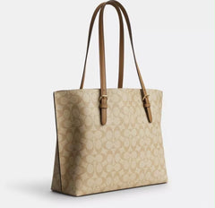 the Coach Mollie Tote in Signature Canvas, designed with the brand's iconic 'C' monogram pattern