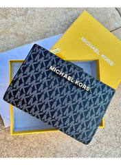 Michael Kors wallet features the brand's signature monogram pattern in black with prominent