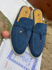 Loro Piana Summer Charms Walk suede mules in a deep blue finish, accented with the brand's