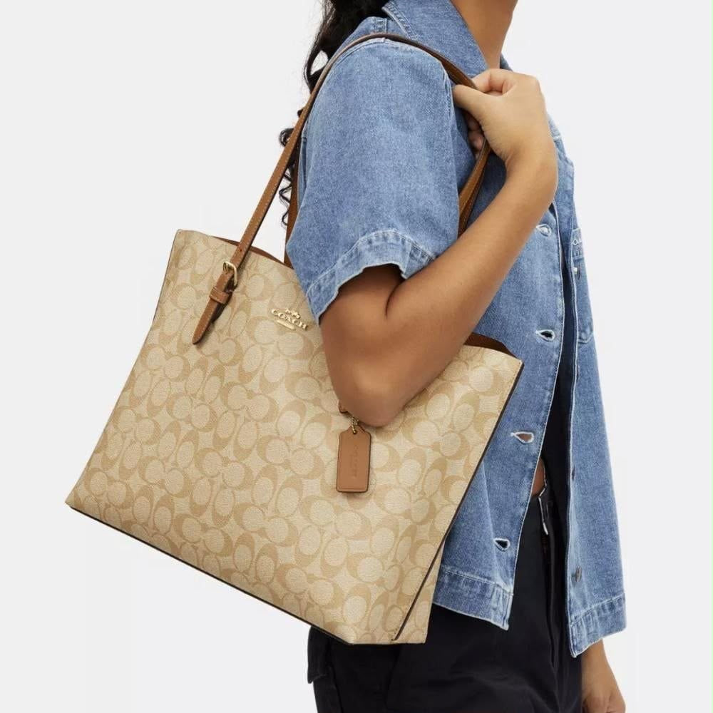 the Coach Mollie Tote in Signature Canvas, designed with the brand's iconic 'C' monogram pattern