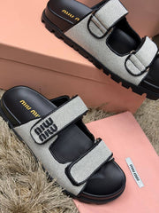 Miu Miu white mesh and black leather double-strap flat slide sandals featuring the distinctive
