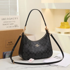 the Coach Teri Hobo in Signature Canvas, featuring a dark charcoal-and-black